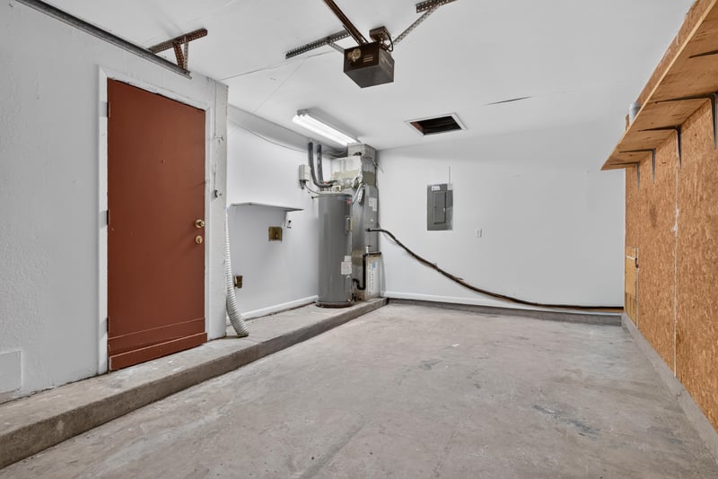 Garage interior with water heater and electrical panel at 8177 Virgo St, Jacksonville, FL 32216