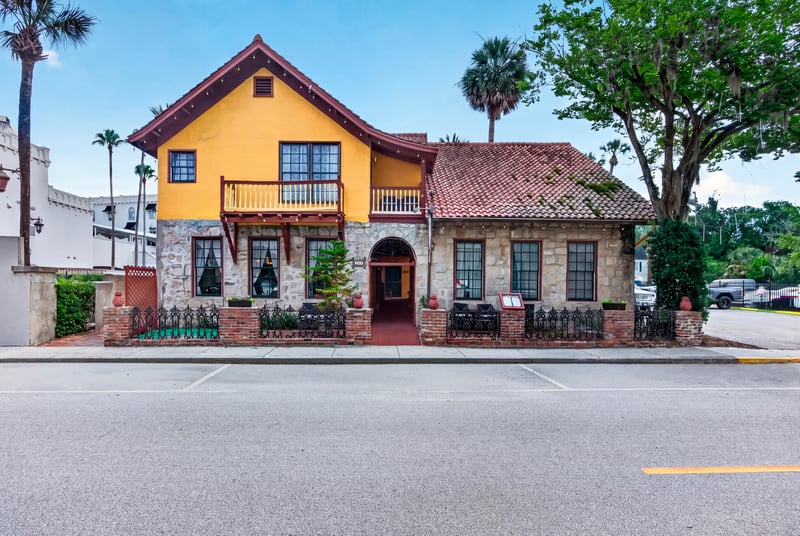 Yellow stucco two-story building with wraparound balconies at 115 Cordova St, St. Augustine, FL