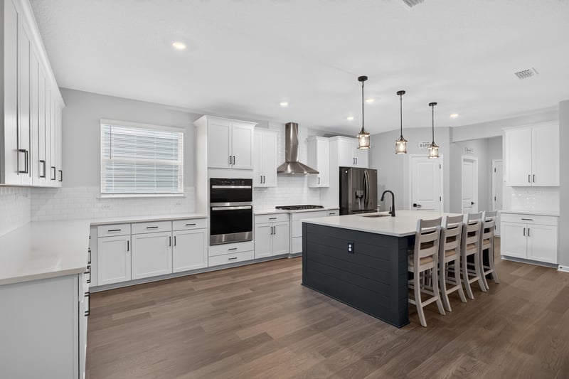 Kitchen with white cabinets and dark island at 2354 Jennings Farm Dr, Middleburg, FL 32068