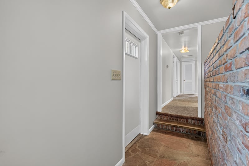 Entry hallway with brick accent wall at 2618 Arlex Dr E, Jacksonville, FL
