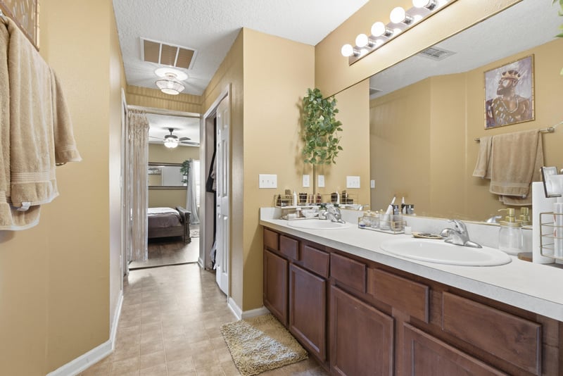 Primary bathroom vanity with hallway view at 7392 Timber Falls Ct