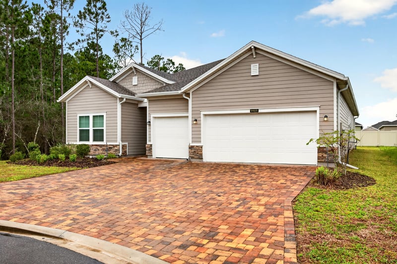 Front exterior with landscaping and driveway at 9905 Ansley Lake Dr, Jacksonville, FL