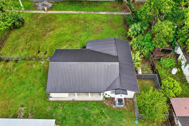 Aerial view of the home's metal roof and side yard at 1619 Hammond Blvd, Jacksonville, FL