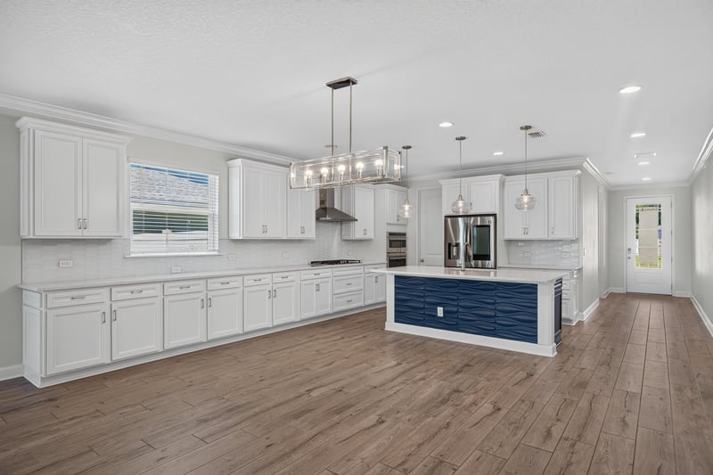 Kitchen with pendant lighting and white cabinets at 855 Flach Dr, St. Johns, FL