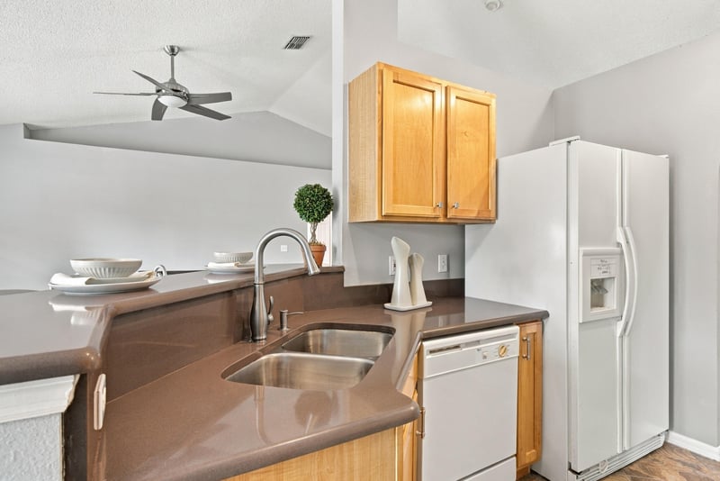 Kitchen island sink with white appliances at 11197 Illford Dr