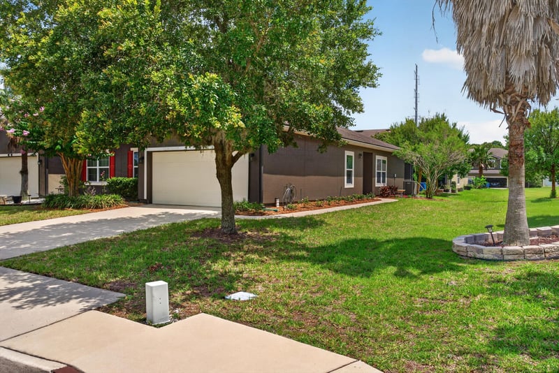 Front exterior view down the driveway and sidewalk at 2378 Caney Oaks Dr, Jacksonville, FL