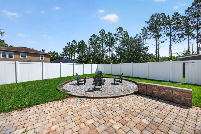 Backyard patio with a built-in fire pit at 3660 Middlebrook Dr, Orange Park, FL 32065