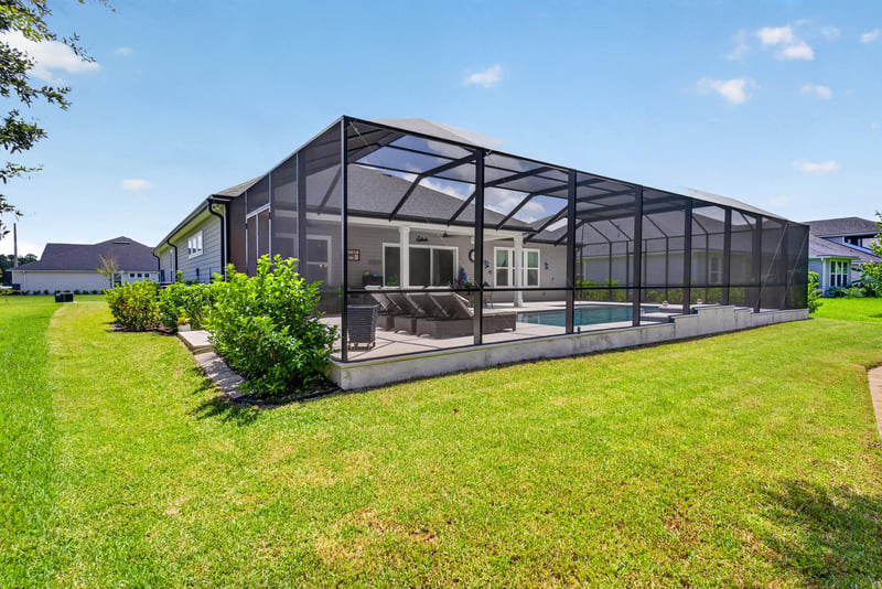 Aerial view of the screened lanai and backyard at 785 Back Creek Dr, St. Augustine, FL 32092