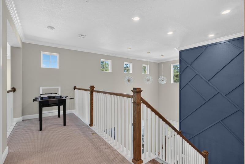 Upstairs hallway with staircase view at 22 Azura Point