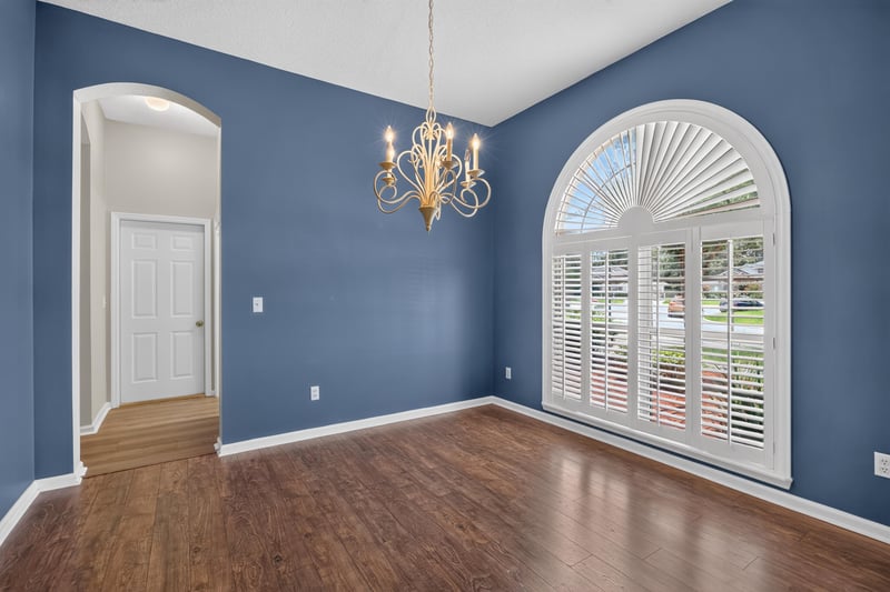 Empty room with blue walls and arched window at 1955 GUARDED Way, Fleming Island, FL 32003