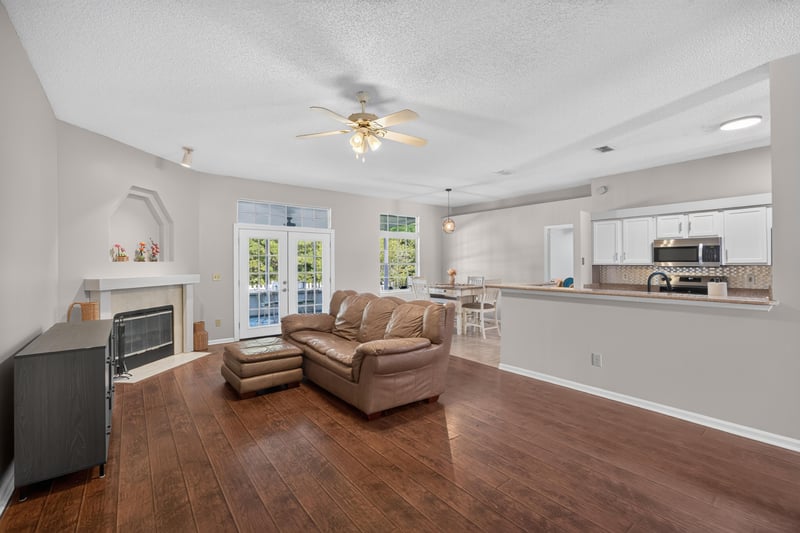 Living room with fireplace and leather sofa at 11828 Heather Grove Ln, Jacksonville, FL