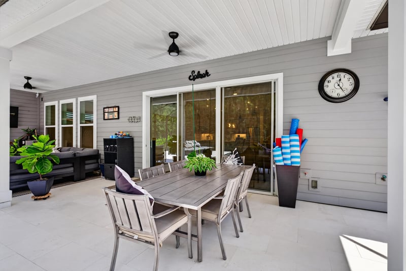 Covered lanai with dining table and sliding doors at 785 Back Creek Dr, St. Augustine, FL 32092