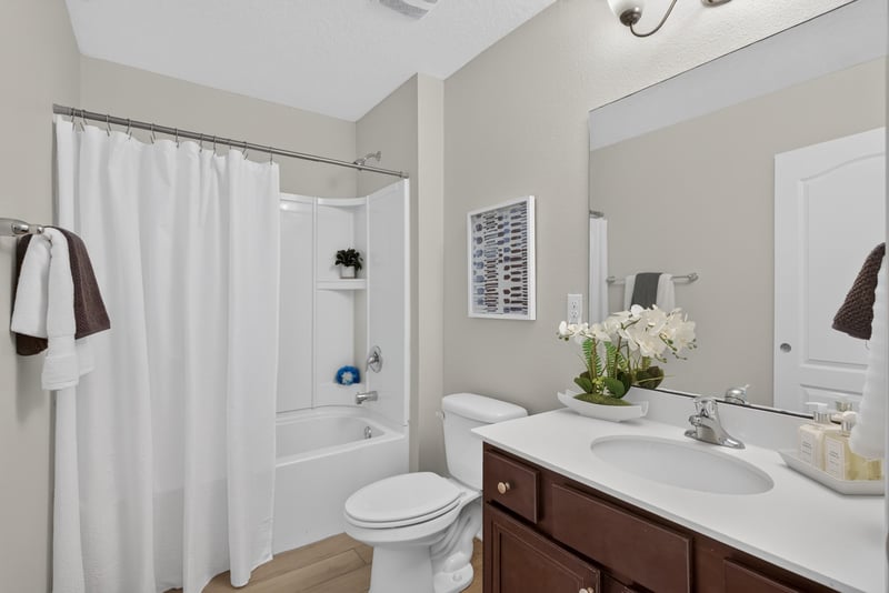 Bathroom with tub-shower combo and pedestal sink at 10066 Andean Fox Dr, Jacksonville, FL 32222