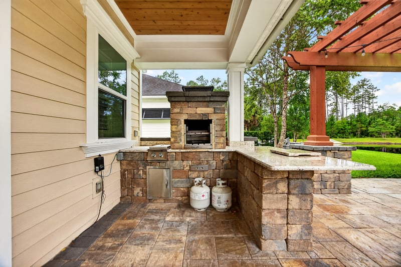 Close view of outdoor kitchen and stone fireplace at 186 Freshwater Dr