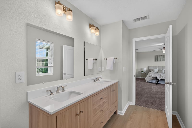 Primary bathroom vanity with door to bedroom at 6830 Hanford St, Jacksonville, FL 32219