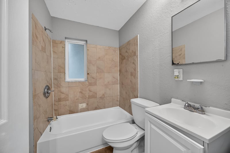 Bathroom with tub-shower and tile surround at 4030 Leonard Cir W, Jacksonville, FL 32209