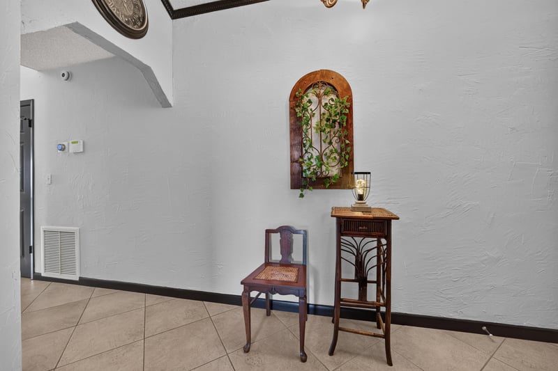 Entry foyer with small table and chair at 6931 Cane Grass Ln E, Jacksonville, FL 32244