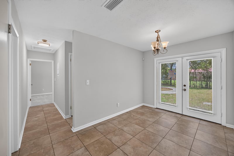 Empty dining area with french doors leading to backyard at 7453 Jade Dr N, Jacksonville, FL 32210