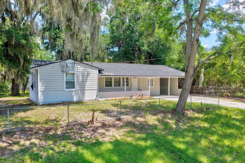 Front exterior with driveway and fenced yard at 855 Cornwallis Dr, Jacksonville, FL