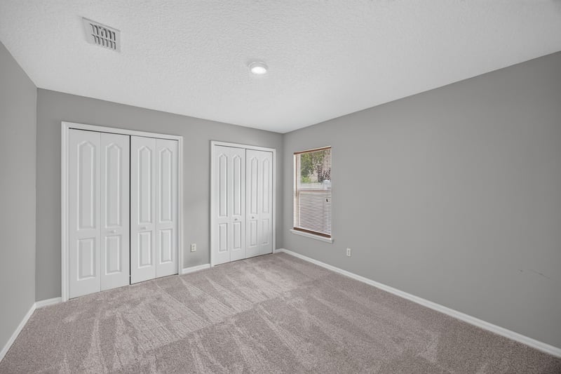 Bedroom with double closet doors at 635 Wakeview Dr, Orange Park, FL 32065