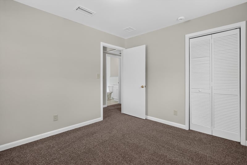 Carpeted bedroom with closet at 2618 Arlex Dr E, Jacksonville, FL
