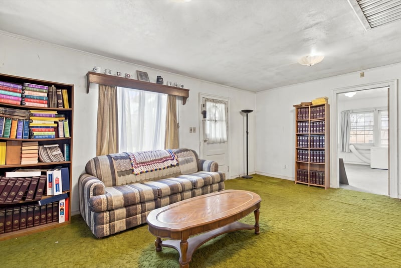 Living room with bookshelves and upholstered sofas at 1807 Idlewild Ave, Green Cove Springs, FL