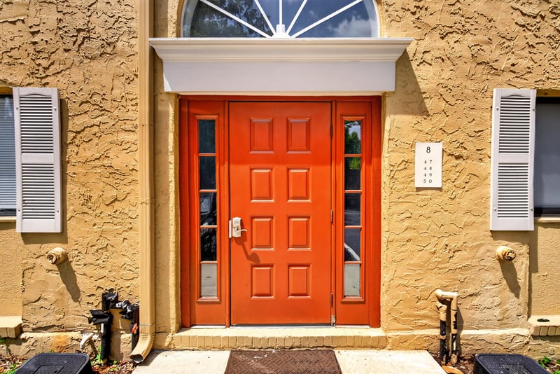 Orange front door with sunburst window at 5811 Atlantic Blvd unit 47, Jacksonville, FL 32207