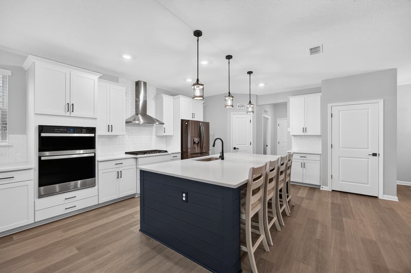 Kitchen with dark island and stainless appliances at 2354 Jennings Farm Dr, Middleburg, FL 32068