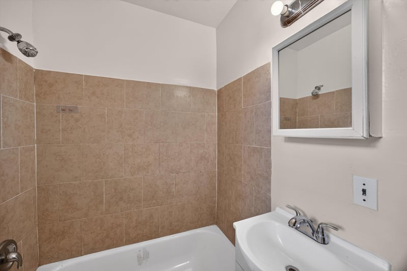 Bathroom with tiled tub surround and sink at 2132 Allandale Cir W, Jacksonville, FL