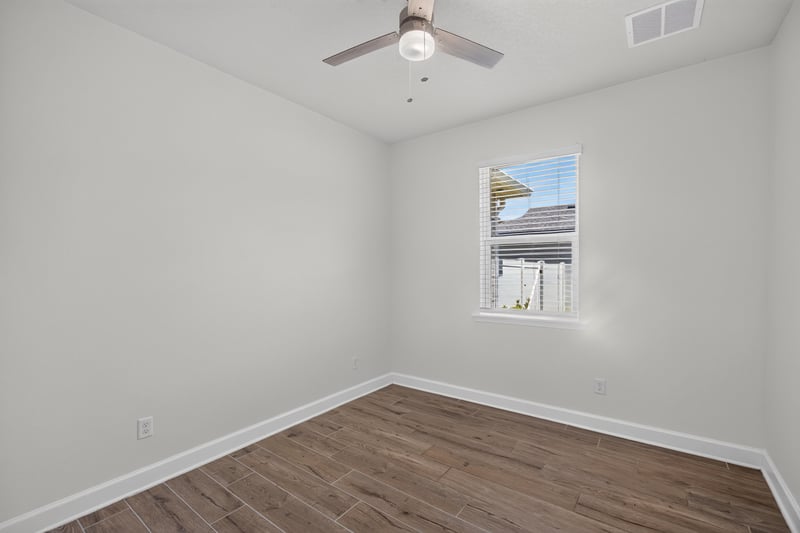 Bedroom with wood floors and window at 855 Flach Dr, St. Johns, FL
