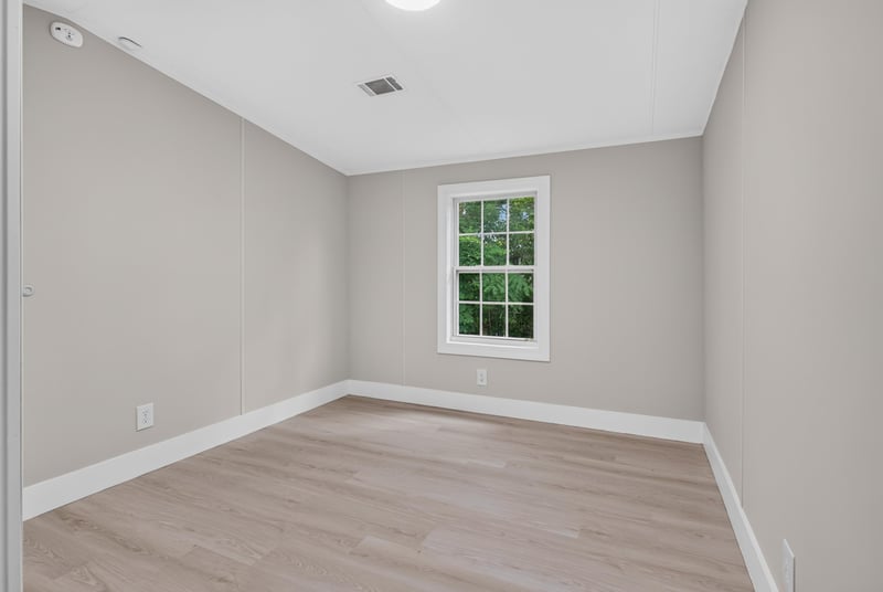 Bedroom with window and wood-look flooring at 4565 Appleton Ave, Jacksonville, FL