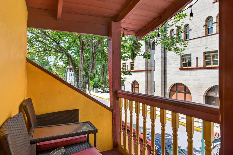 Covered balcony with seating overlooking the street at 115 Cordova St, St. Augustine, FL