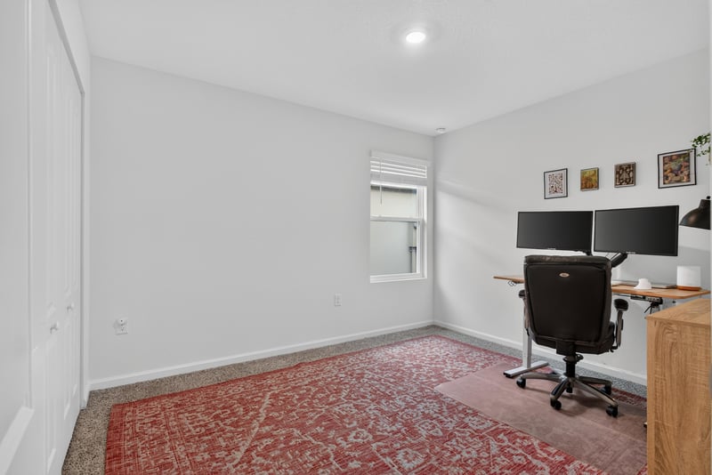 Home office with desk and area rug at 4276 Quaking St, Jacksonville, FL 32218