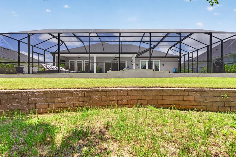 Screened pool enclosure viewed from the yard at 785 Back Creek Dr, St. Augustine, FL 32092