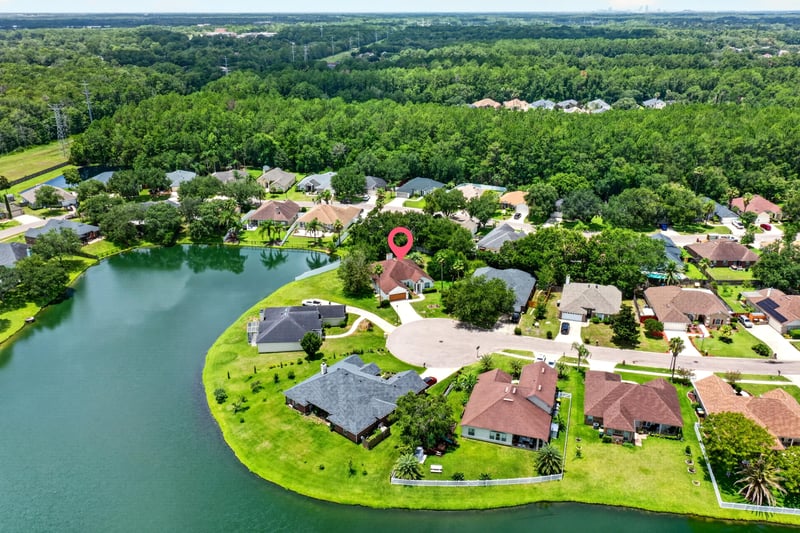 Aerial view of the home among lakefront rooftops at 2480 Ridge Will Dr, Jacksonville, FL 32246