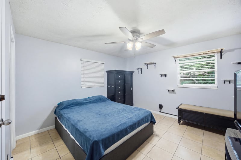 Bedroom with dark dresser and blue bedding at 417 Capricorn Ln, Orange Park, FL 32073