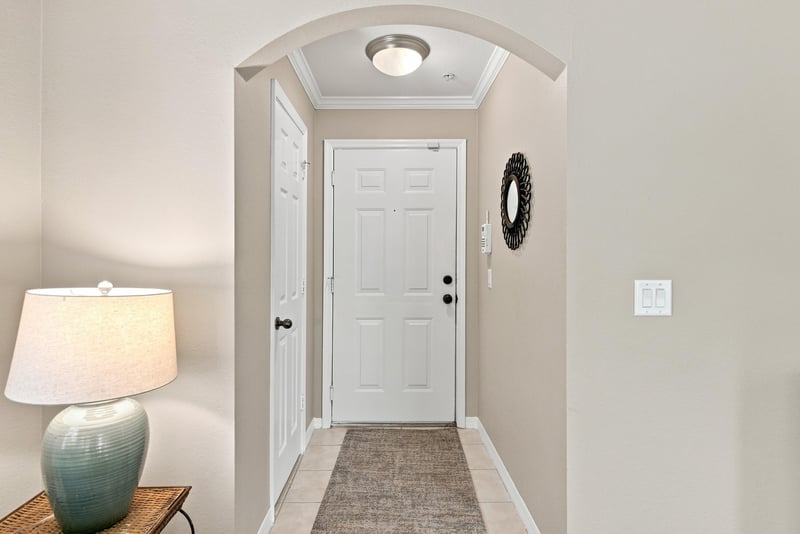 Entry hallway with front door and wall mirror at 7800 Point Meadows Dr, Jacksonville, FL 32256