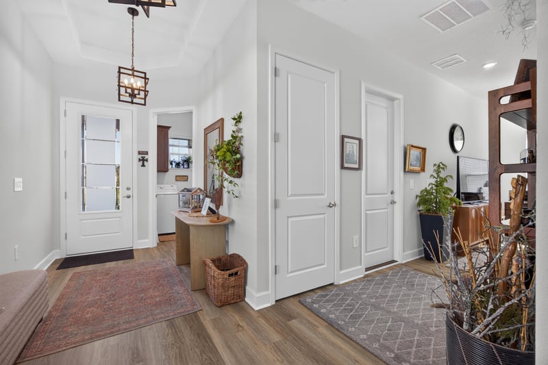 Entry hallway with hardwood floors and closet doors at 129 Amberwood Dr, St. Augustine, FL