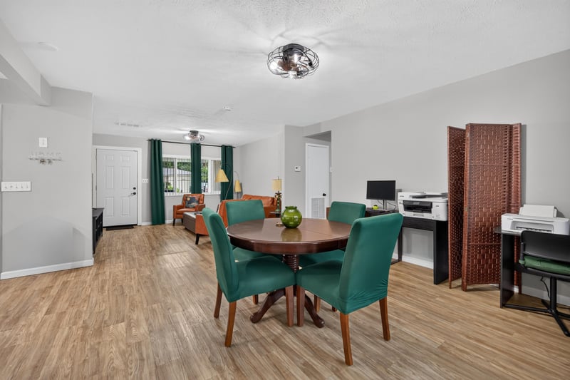 Dining area with wood-look flooring and natural light at 9506 Harriet Ave, Jacksonville, FL 32208