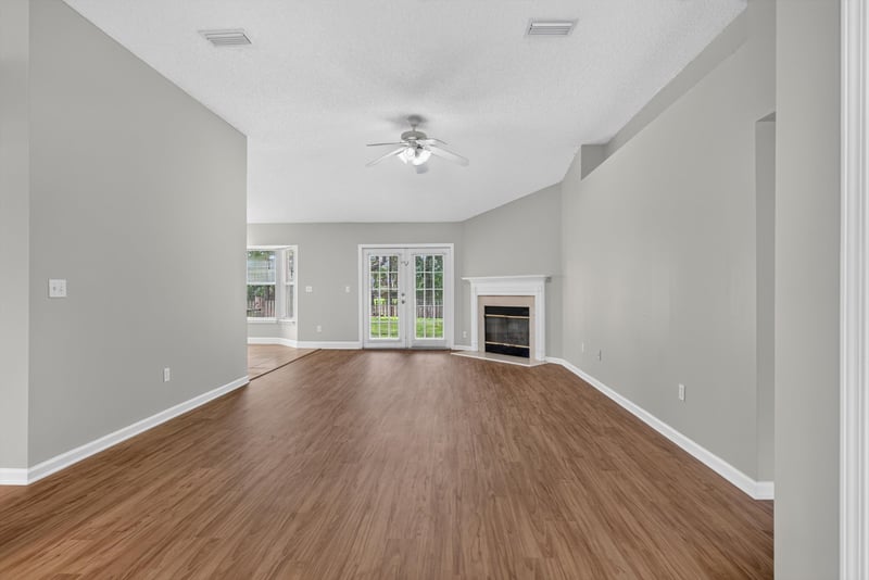 Living room with wood floor and French doors at 12949 Chets Creek Dr S, Jacksonville, FL 32224