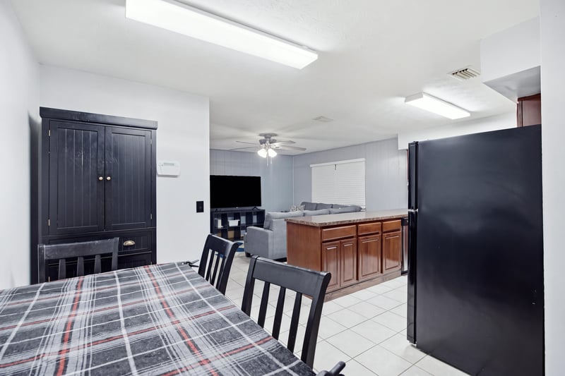 Dining area with wood table and black refrigerator at 417 Capricorn Ln, Orange Park, FL 32073