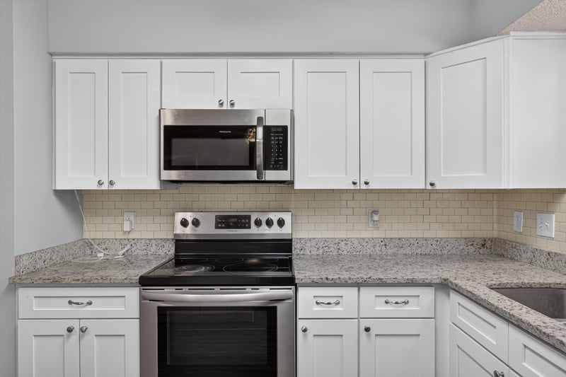 Kitchen with white cabinets and stainless microwave at 12344 Cormorant Ct, Jacksonville, FL
