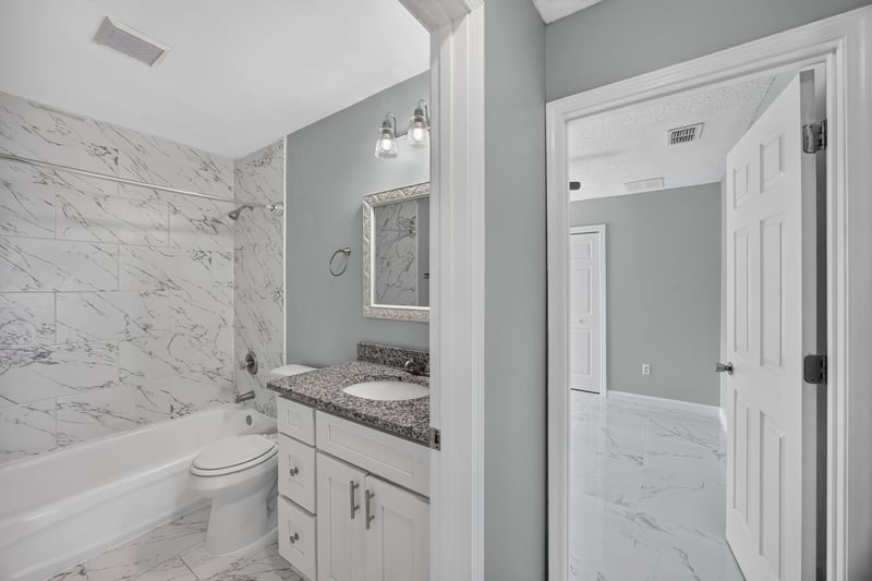 Bathroom with tub, shower, and granite vanity at 490 Hillside Dr, Orange Park, FL 32073