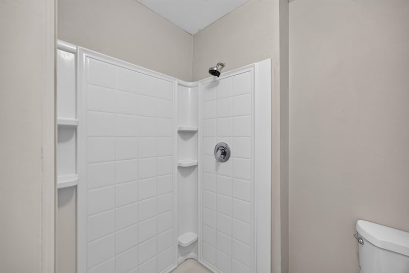 Primary bath shower stall with tile walls at 1845 Saga Ct, Middleburg, FL