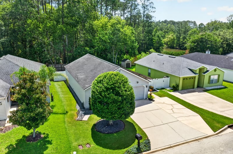 Drone view over neighboring rooftops and lawns in Middleburg, FL