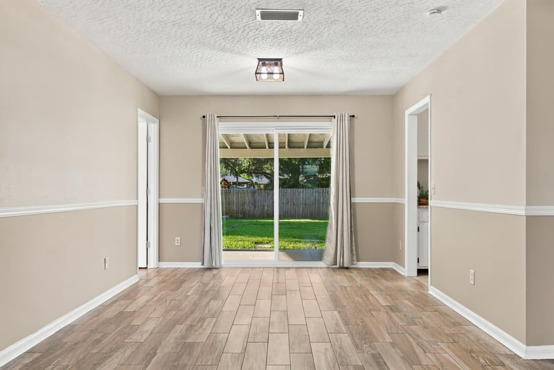 Living room interior view with sliding glass doors to the yard, photographed by Megapixeler on Crosby Ln, Orange Park