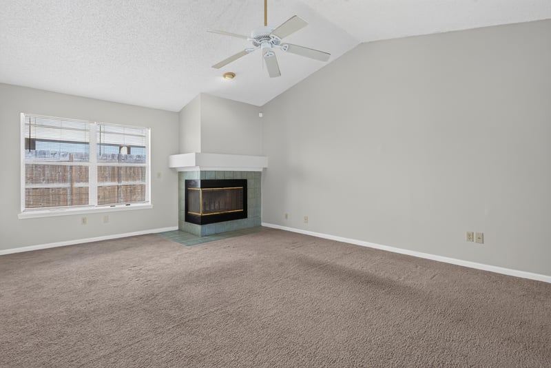 Living room with fireplace and large window at 400 Ashcroft Landing Dr, Jacksonville, FL 32225