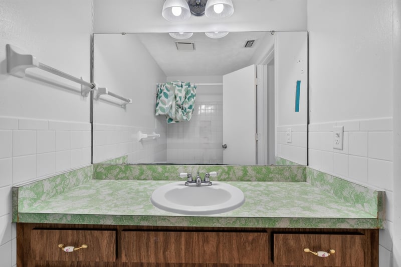 Bathroom vanity and mirror at 9954 Larkdale Ct, Jacksonville, FL 32257