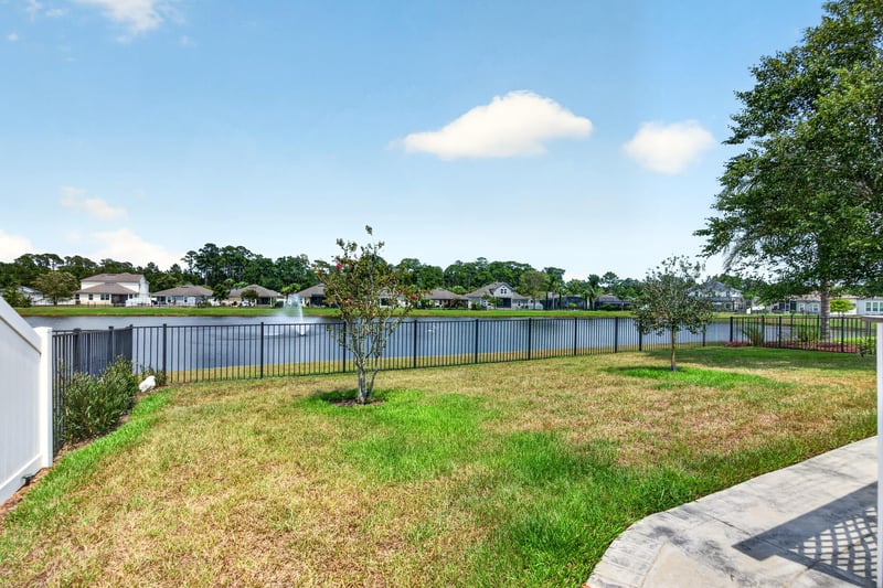 Backyard view of fence line and adjoining lake at 85 Amia Dr, St. Augustine, FL 32086