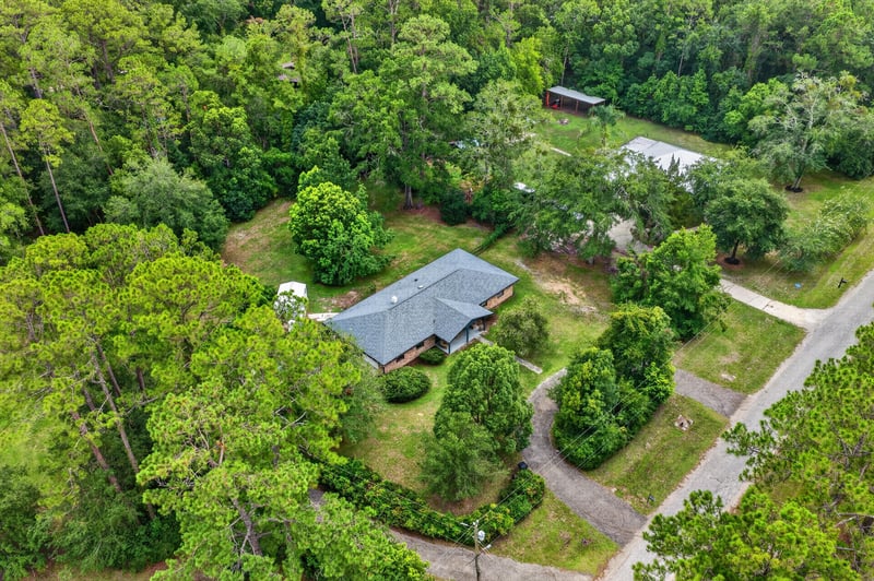 Aerial view of the home surrounded by trees and lawn at 3249 Maryland Ave, Green Cove Springs, FL